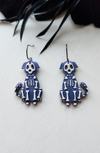 Load image into Gallery viewer, Colorshift Skelly Dog Dangle Earrings
